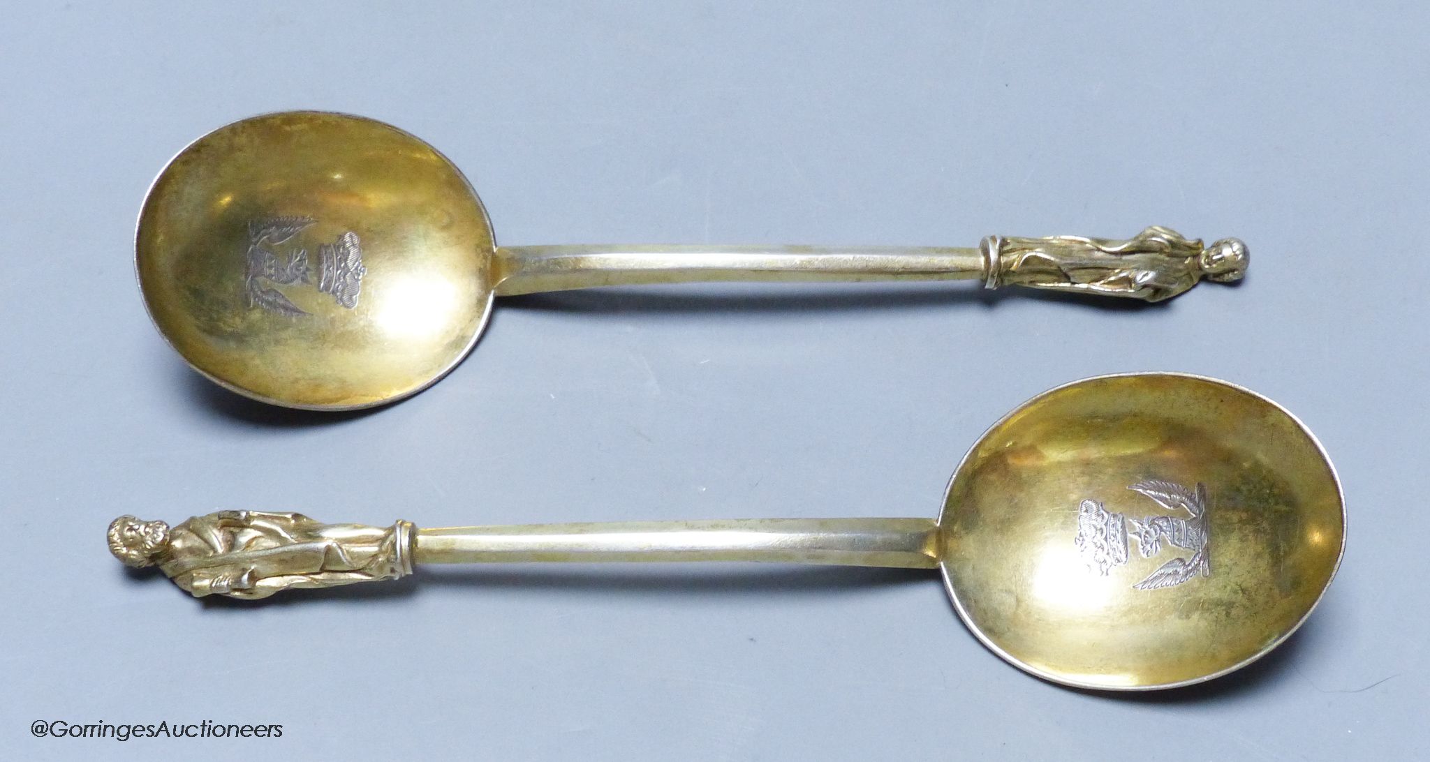 A pair of 19th century Hungarian? gilt white metal apostle spoons, 19.1cm, with engraved crests, 137 grams.